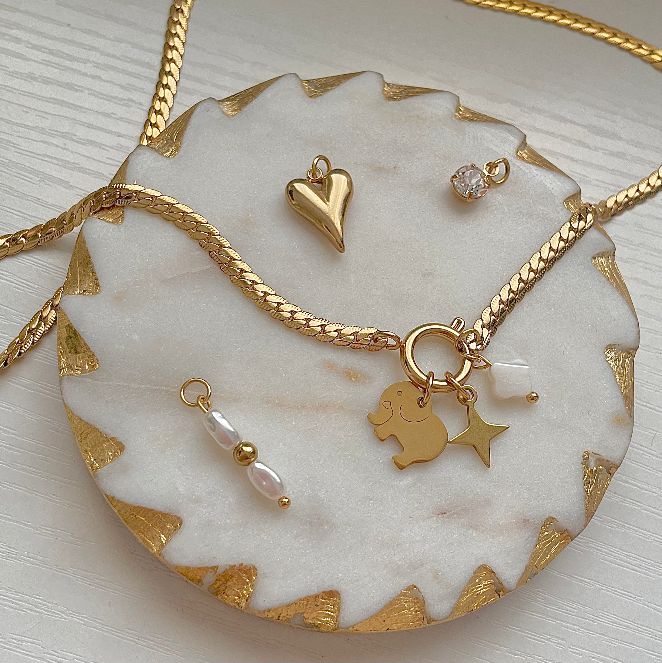 Baby Elephant Charm on a gold charm necklace uk