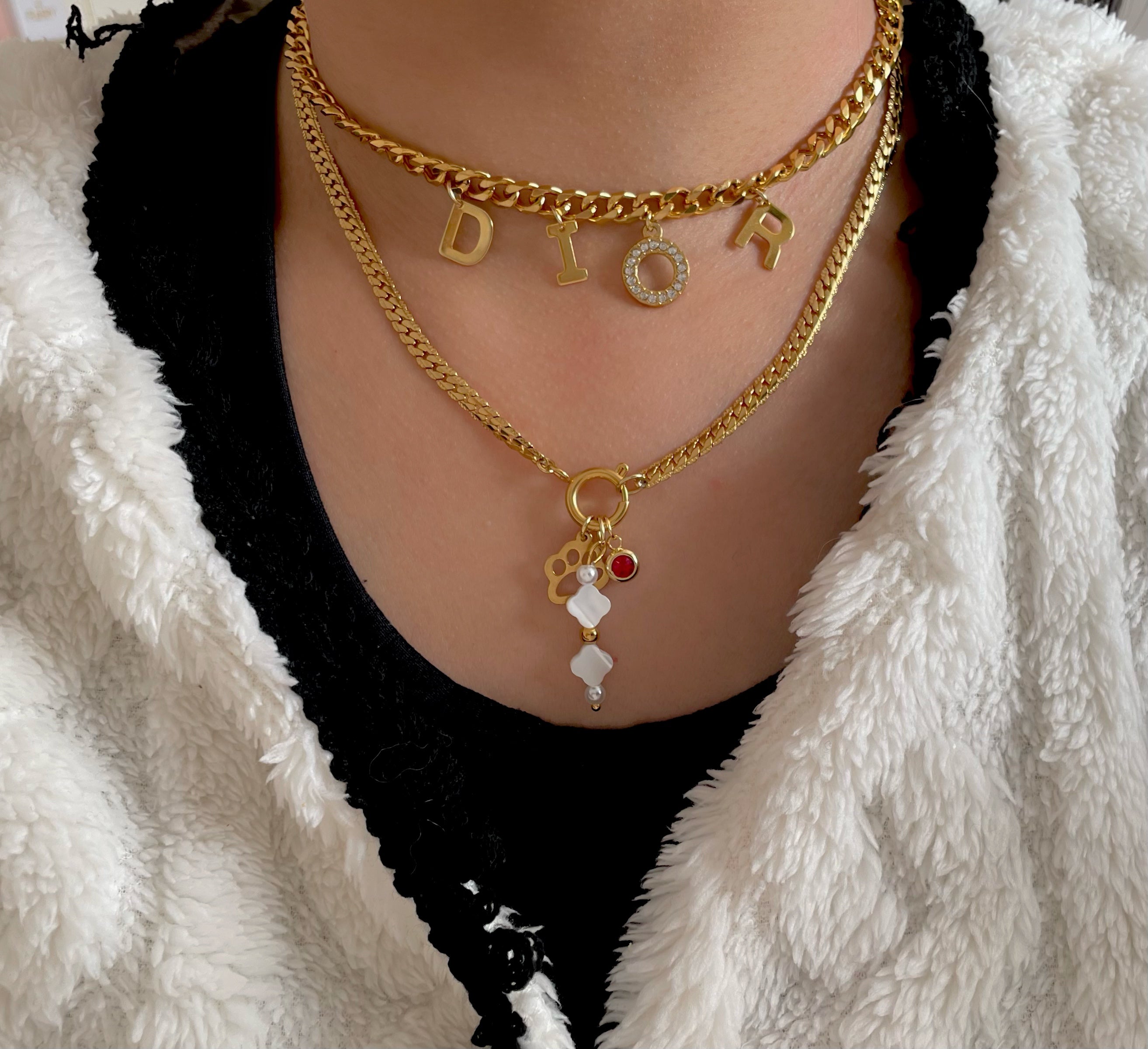 Name necklace with a gold charm necklace