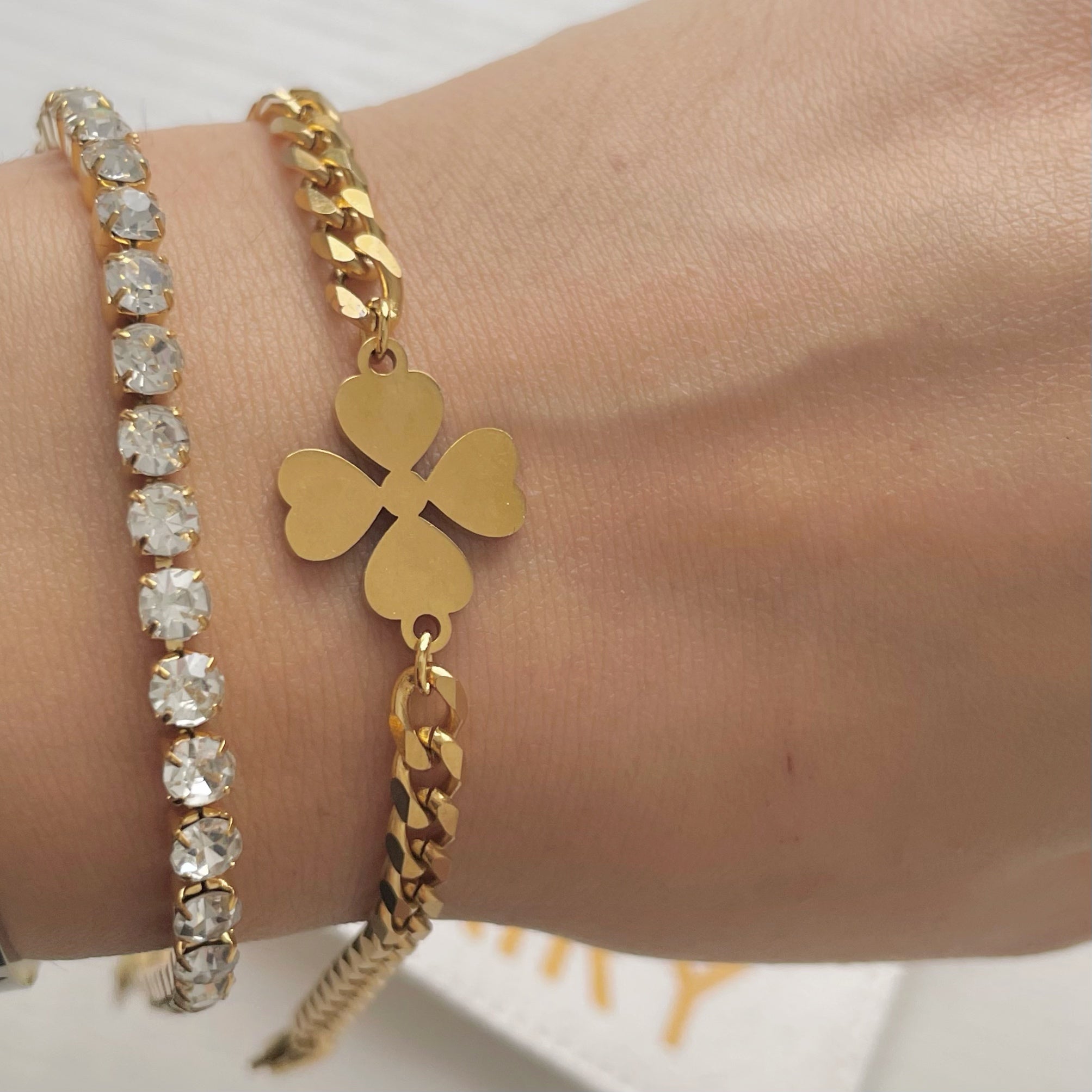 gold clover bracelet and gold tennis bracelet