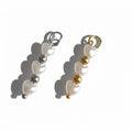 charms with white heart-shaped pendants and gold and silver accents on a white background