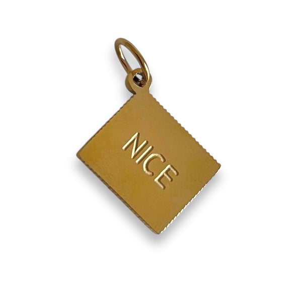 Gold pendant with 'NICE' engraving on a white background