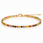 Multicolored gemstone bracelet on a gold band against a white background