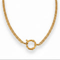 A gold-colored necklace with a round clasp, displayed against a white background.