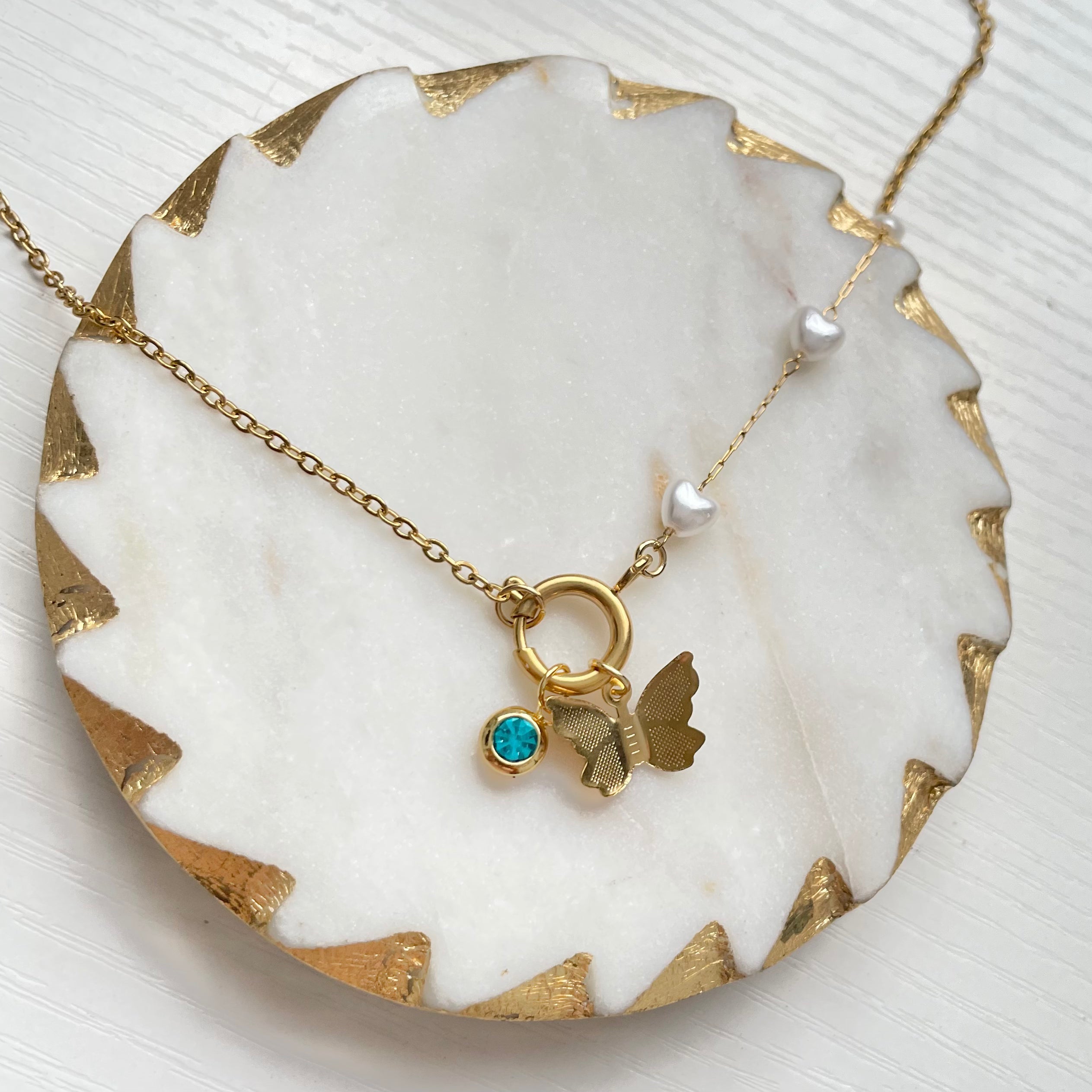 Gold charm necklace with heart pearls and butterfly charm and birthstone charm