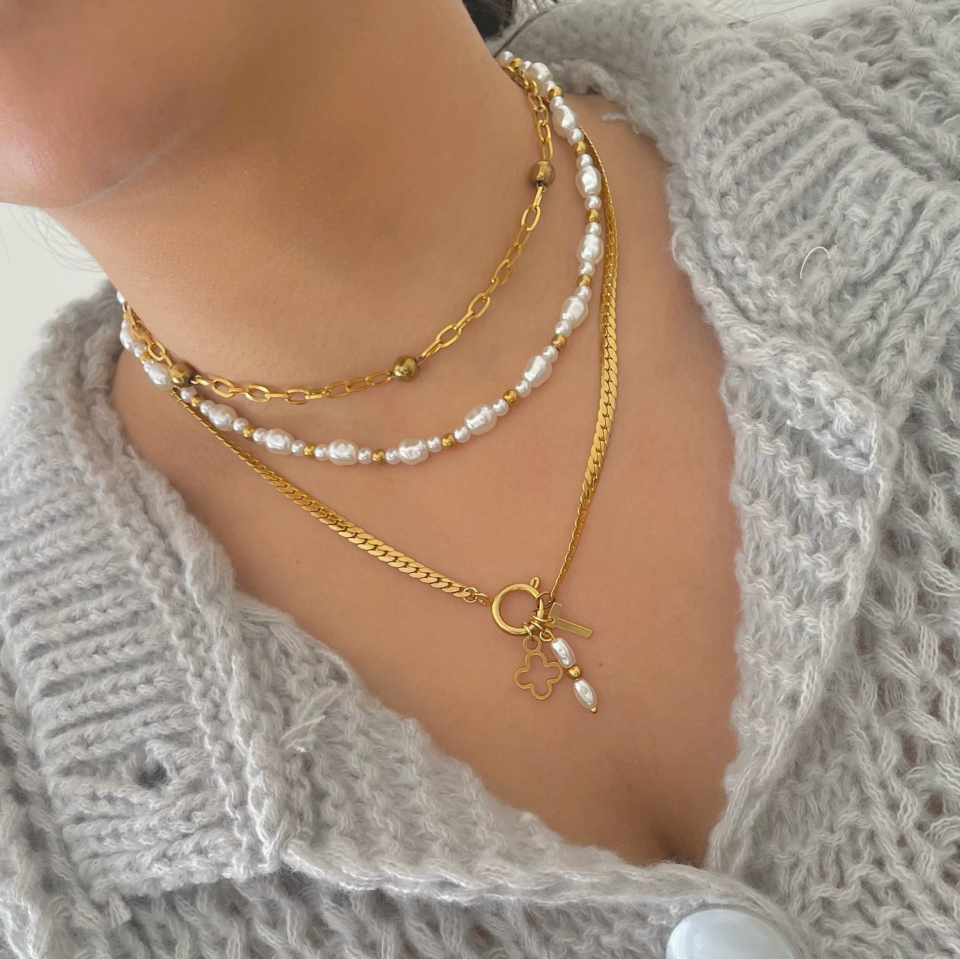 Gold necklace stack with charm necklace and pearl necklace