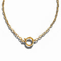 A gold-colored grand link charm necklace with a round clasp, displayed against a white background.