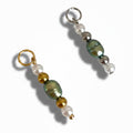 Two olive green beaded pearl charms with silver and gold beads, designed for use with jewelry such as necklaces or bracelets.