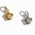 Two petite crystal flower charms, one gold-colored and one silver-colored, each with a crystal center.