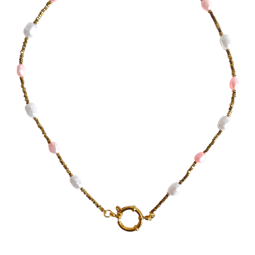Necklace with pink and white beads on a white background
