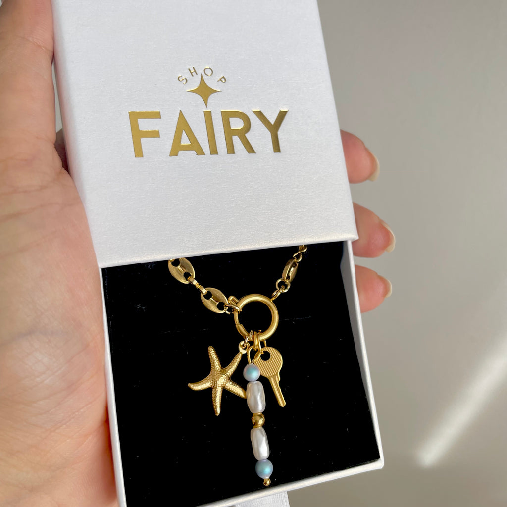 Starfish Charm with key charm on a gold charm necklace