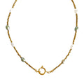 Necklace with gold chain and green beads on a white background