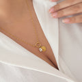 Twirl Charm Necklace Gold with a heart charm and crystal charm
