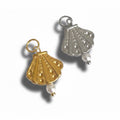 Two seashell-shaped charms with pearl beads at the bottom, one in gold color and one in silver, displayed against a white background.