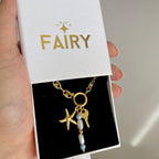 charm necklace with gold charms in a gift box