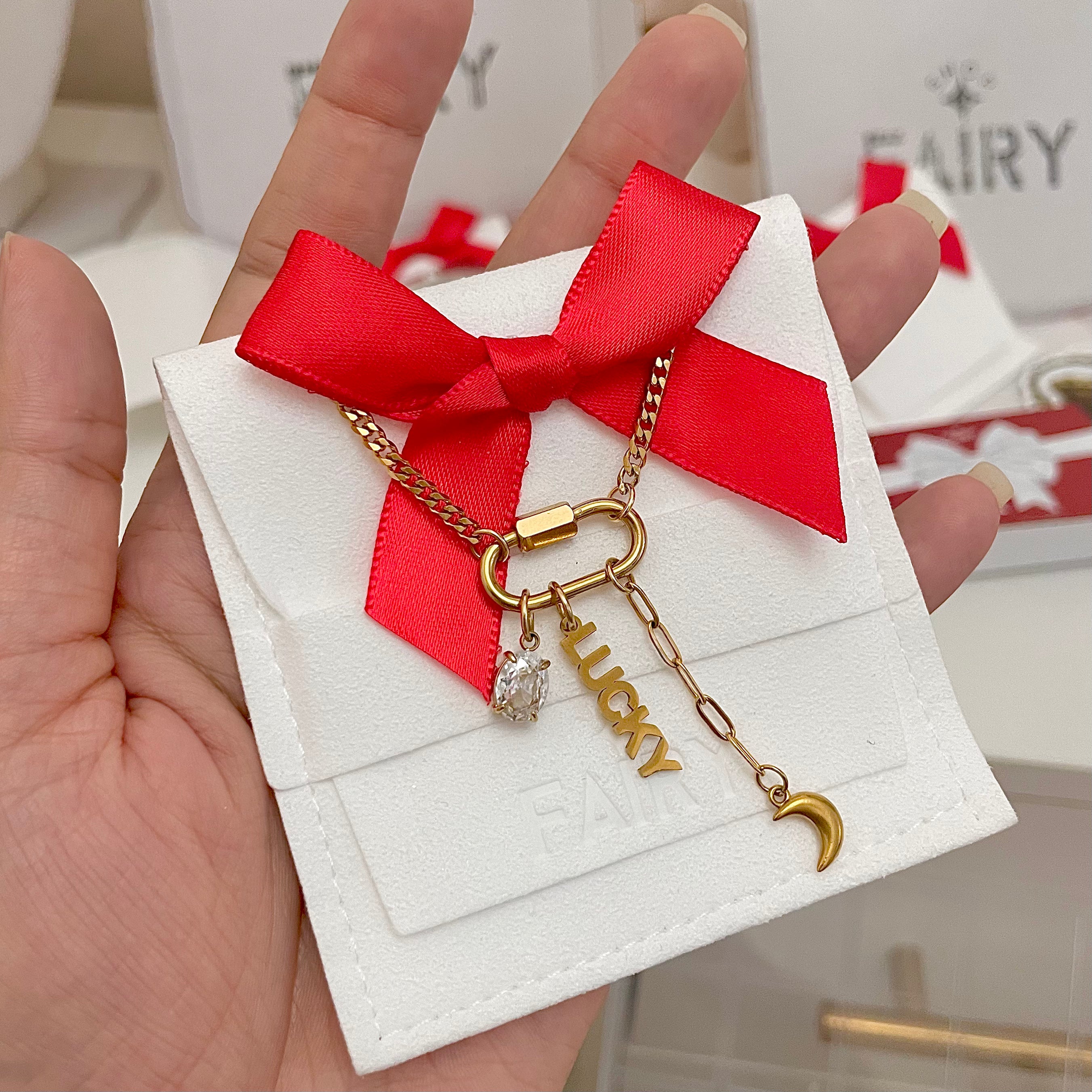 Oval clasp charm necklace with three cute gold charms