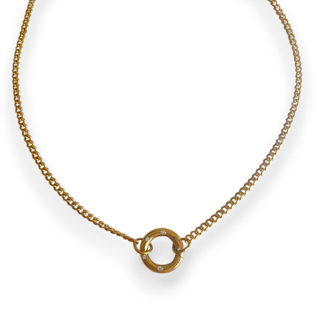 Gold necklace with a circular pendant on a white background