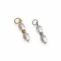 Two pearl charms with gold and silver accents, designed to be attached to jewelry items like necklaces or bracelets.