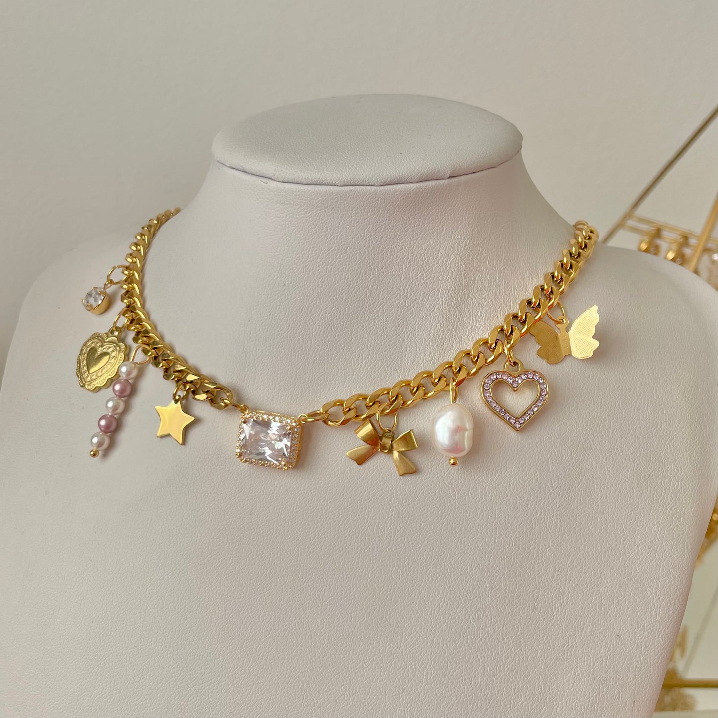 dreamy gold charm necklace with hearts and ribbons