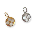 Two circular pendants, one gold and one silver, on a white background