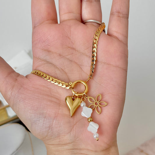 flower charm on a gold charm necklace 