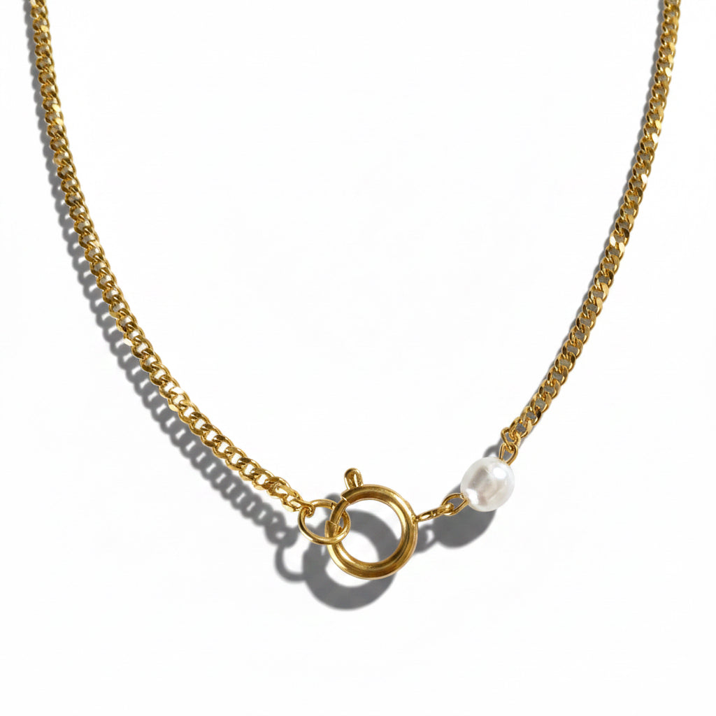Gold chain necklace with a clasp on a white background