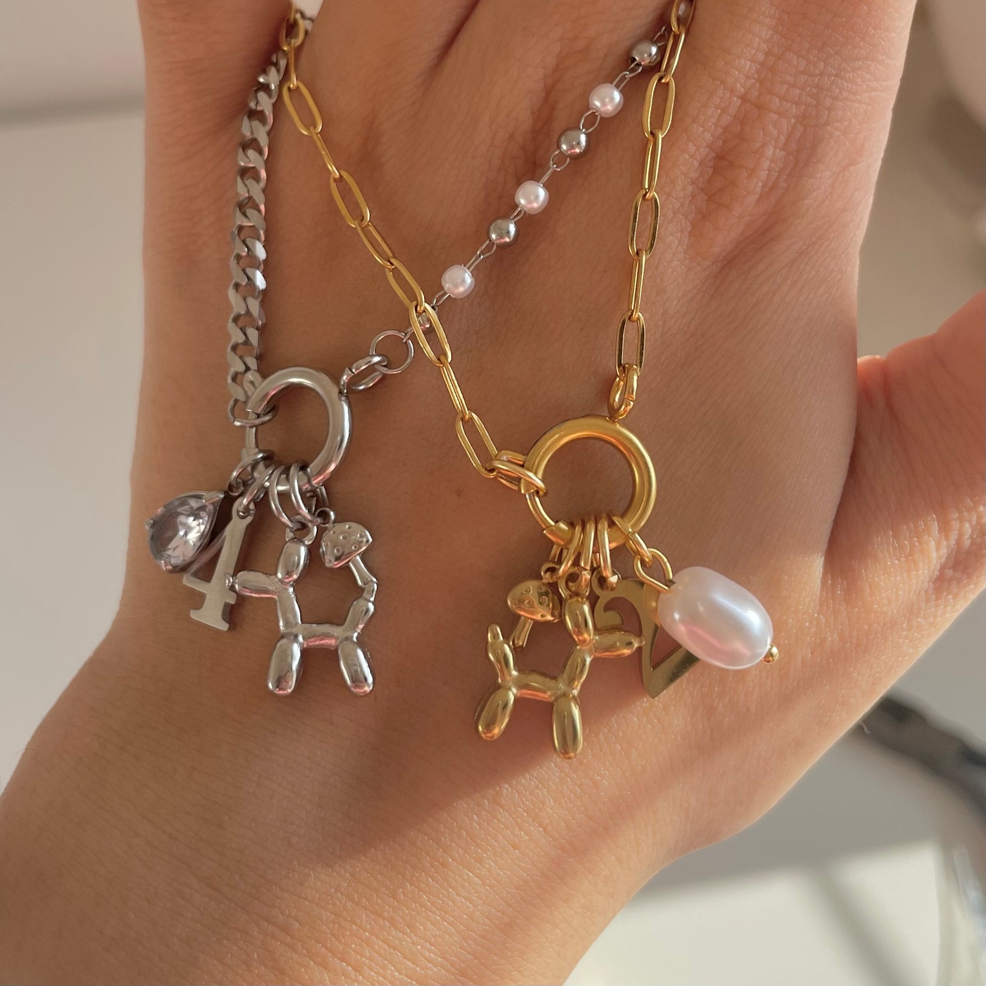 gold dog charm and silver dog charm