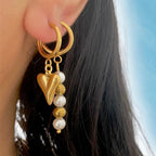 gold earrings stack with pearl earrimgs and heart earrings