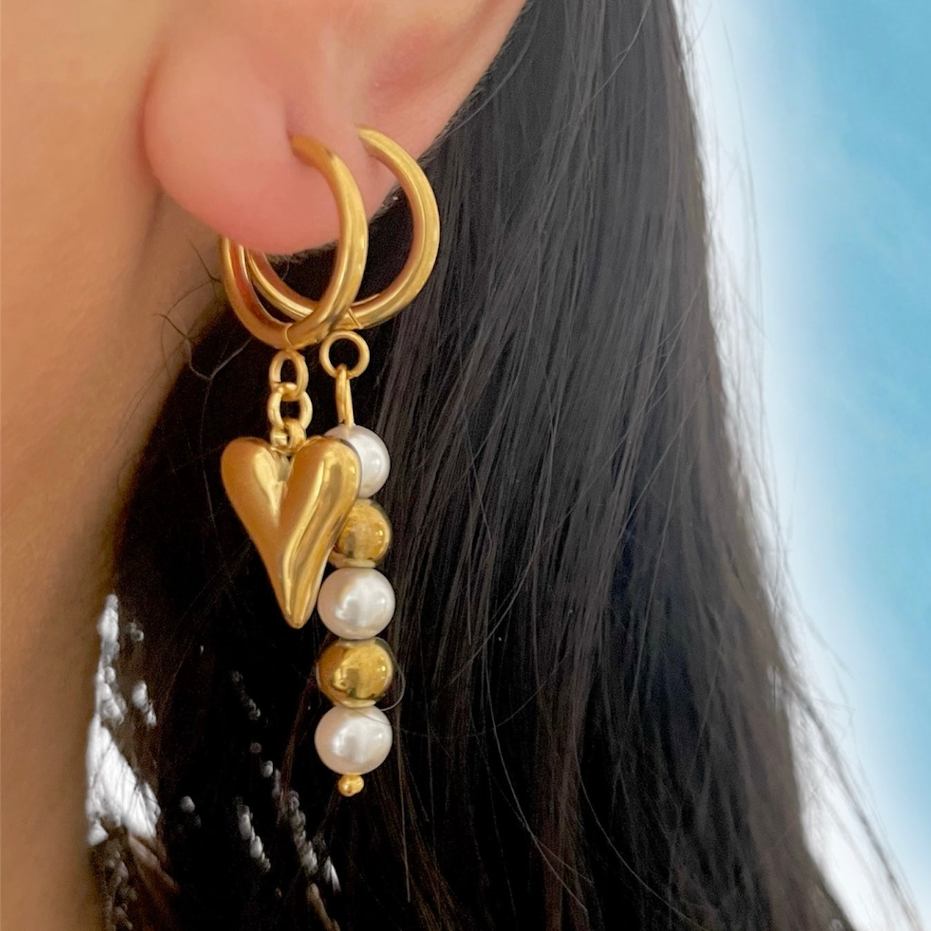 gold earrings stack with pearl earrimgs and heart earrings