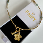 Gold necklace with a flower charm and cowboy boot. charm 