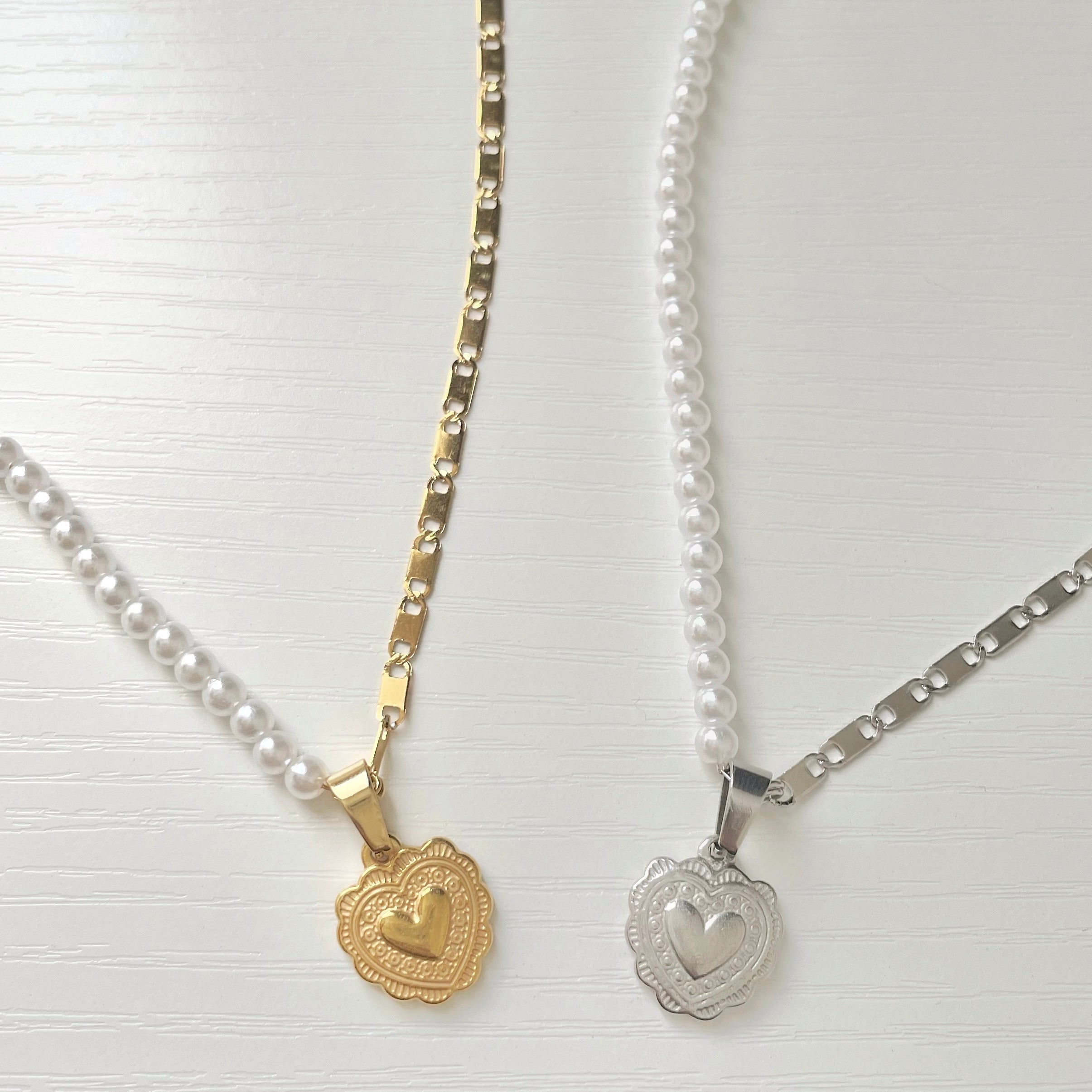 half pearl necklace with heart charm