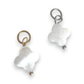 Two white shell closer charms  on a white background