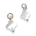 Two white shell closer charms  on a white background