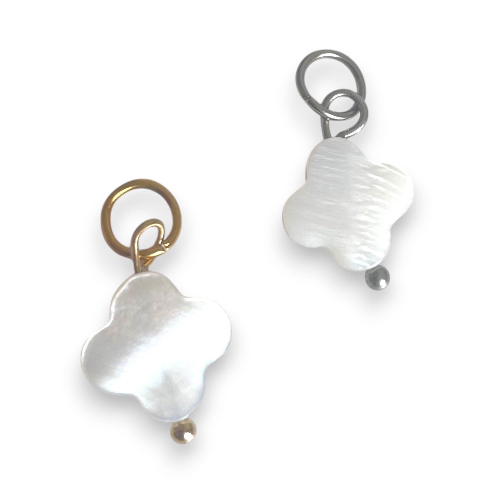 Two white shell closer charms  on a white background