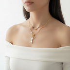 Gold necklace with floral charms on a mannequin bust against a white fur background