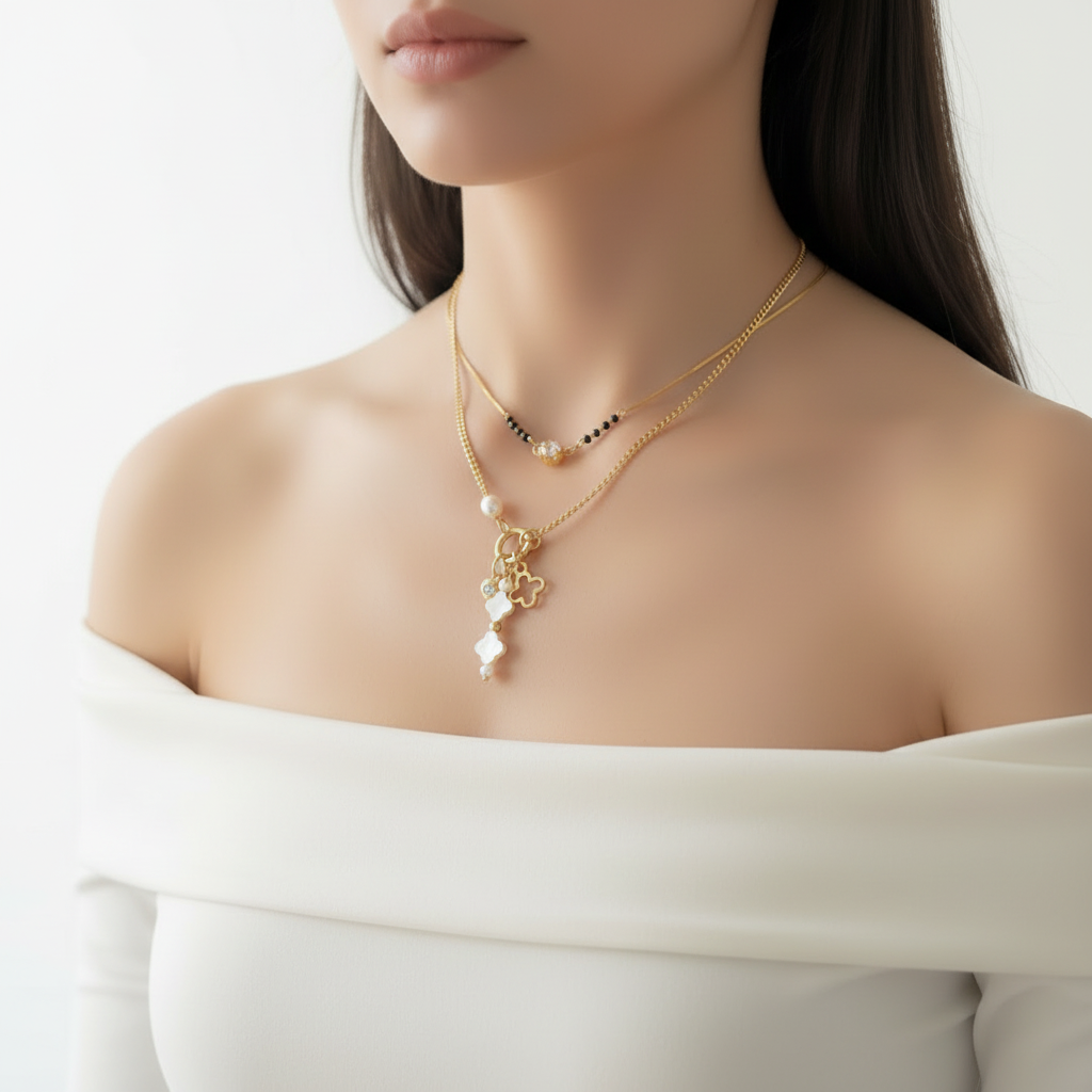Gold necklace with floral charms on a mannequin bust against a white fur background