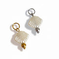 Two pearl seashell charms with gold and silver beads, isolated on a white background.