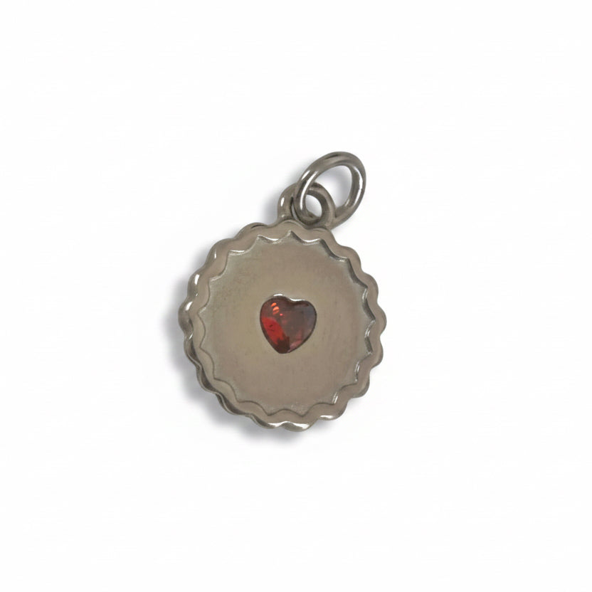 Silver Jammie dodger pendant with a red heart charm on a white background