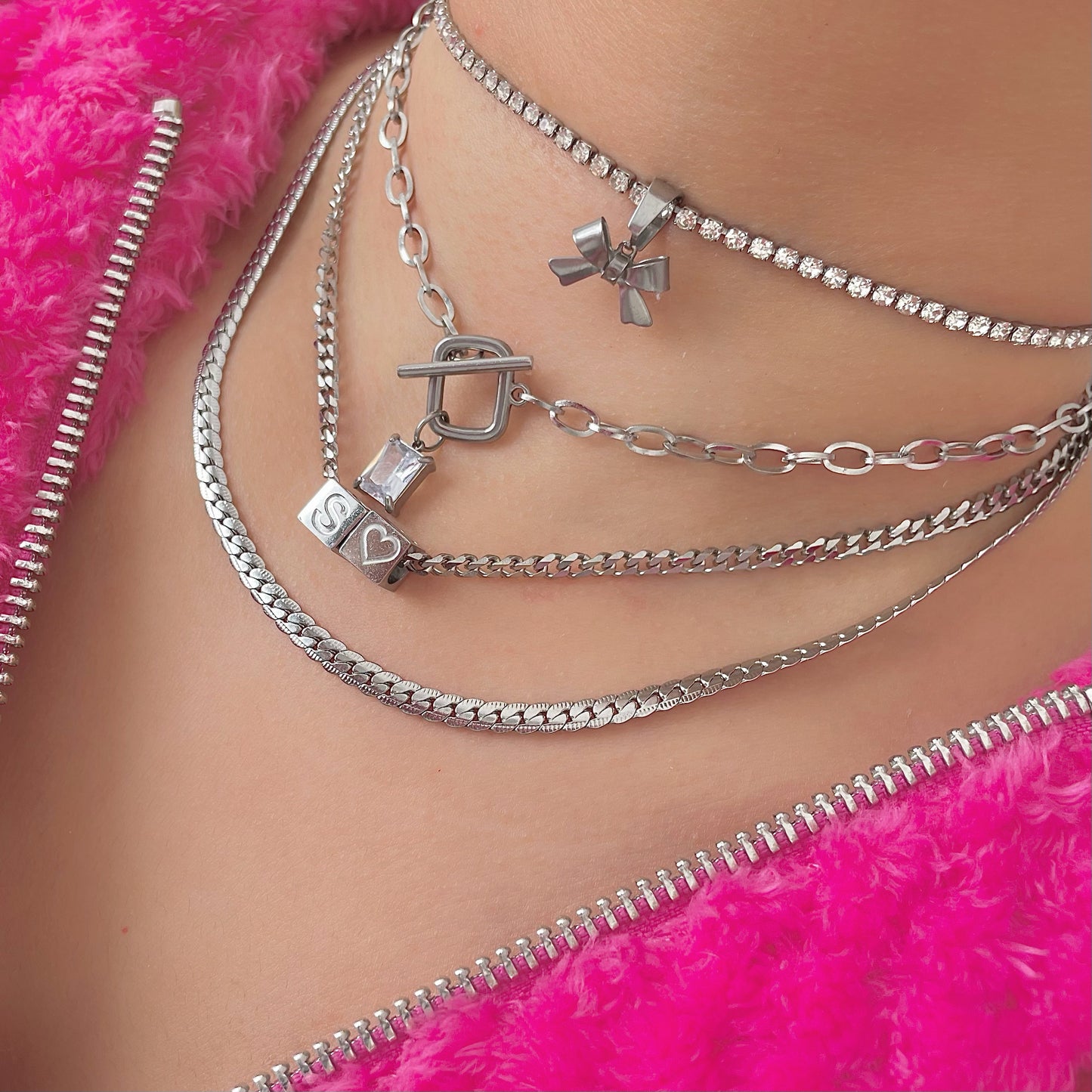 silver ribbon necklace with a silver dice initial necklace