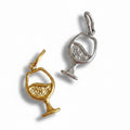 Gold and silver wine glass pendants on a white background
