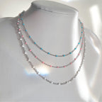 dainty silver necklaces with blue pink white enamel