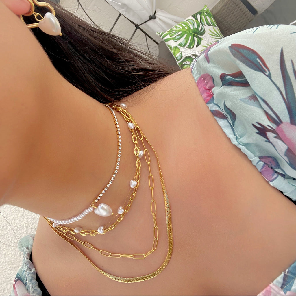 gold necklace stack with pearls