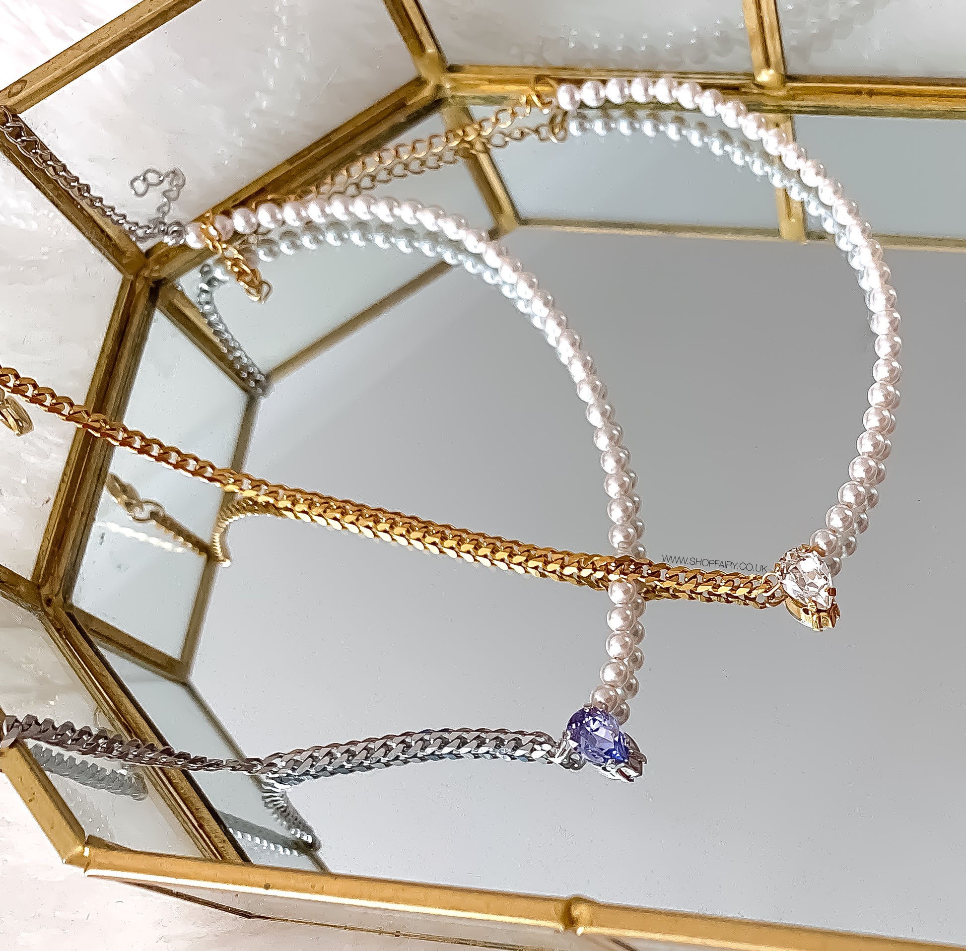 gold pearl necklace and silver pearl necklace
