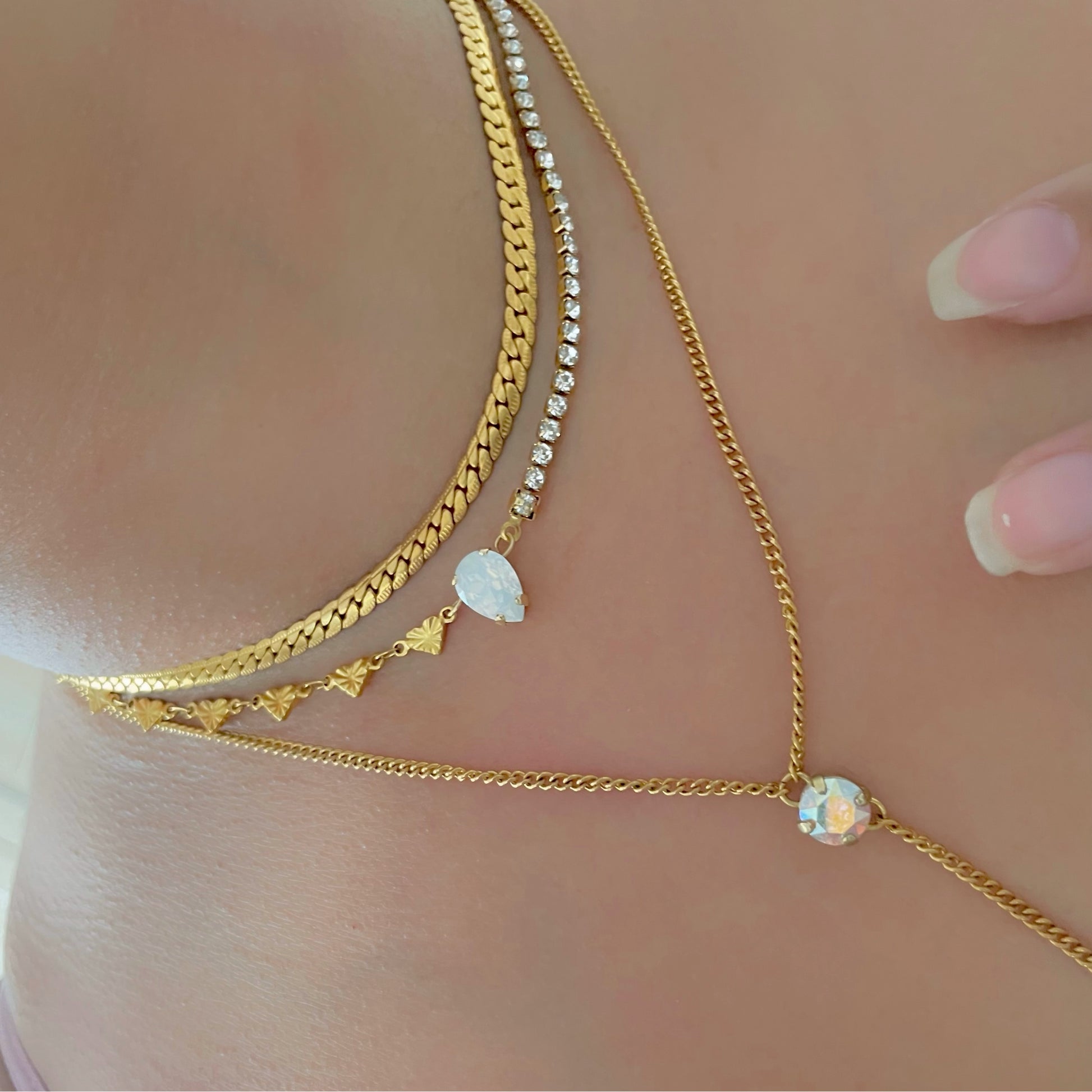 half tennis necklace and half heart necklace with crystal in the centre