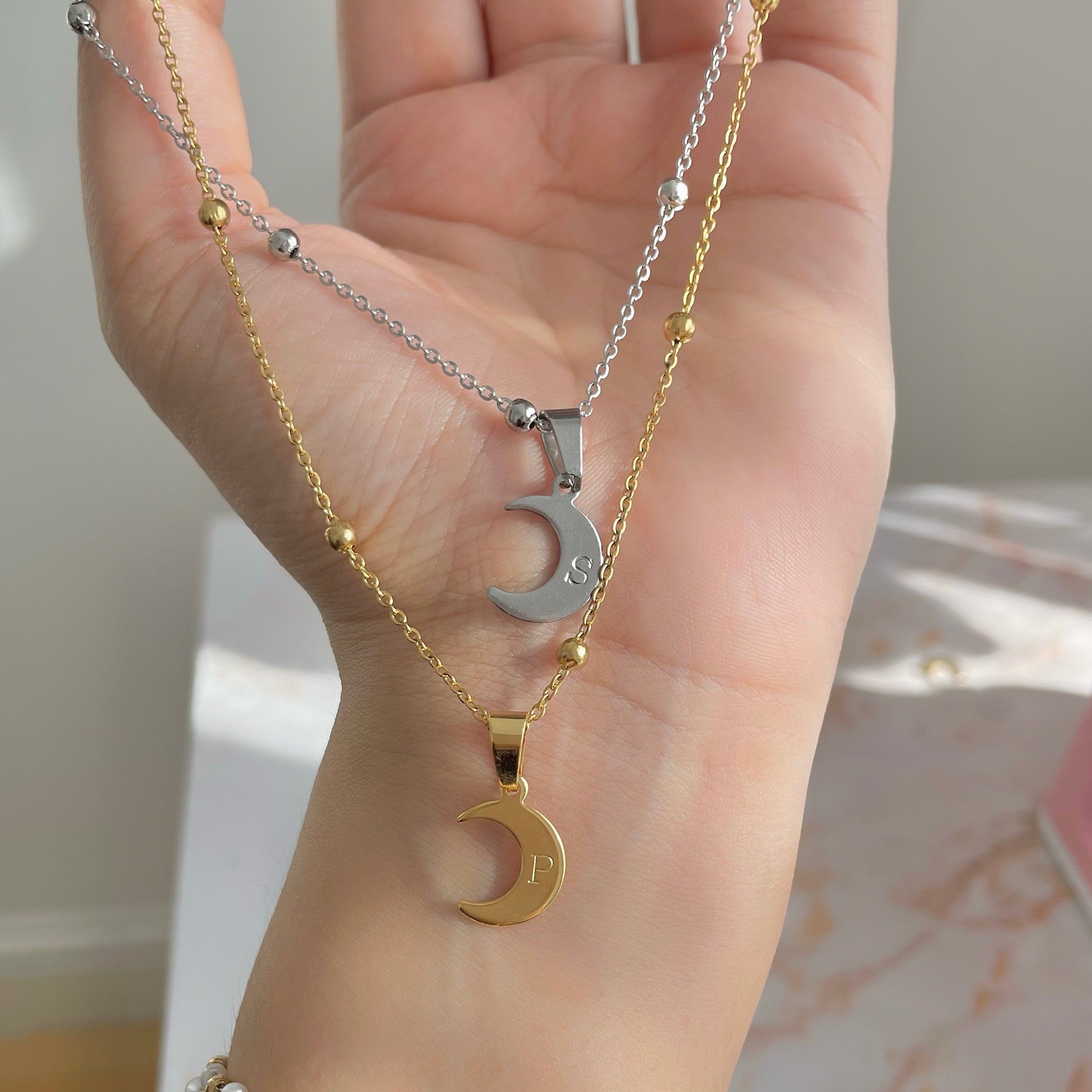hand stamped initial necklace on a crescent moon charm