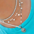 silver necklace stack with a tennis necklace and pearl necklace